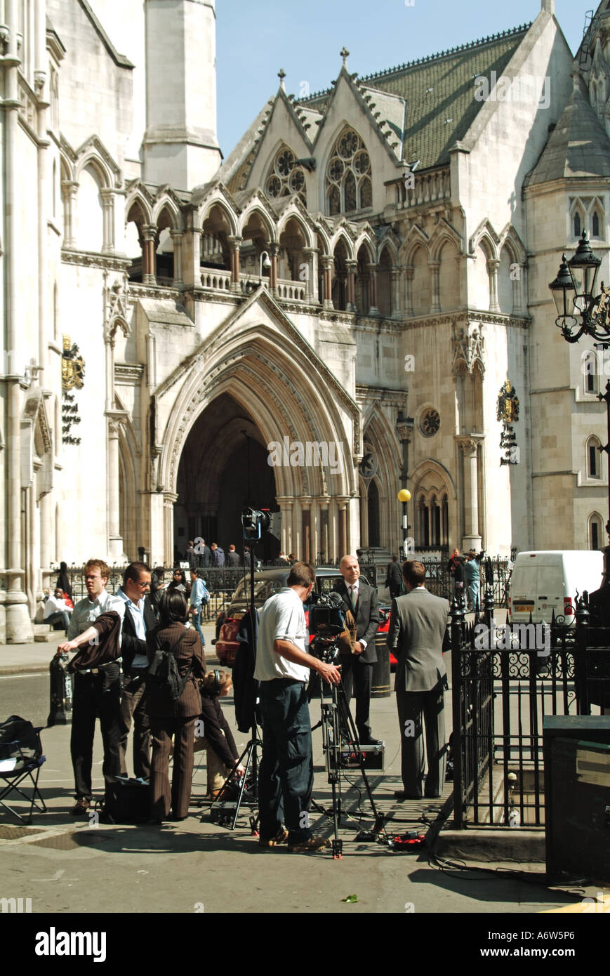 Nachrichtenreporter und Journalisten mit Kamerateam bei der Arbeit, Interviews und Berichterstattung außerhalb der Royal Courts of Justice Strand London England Großbritannien Stockfoto