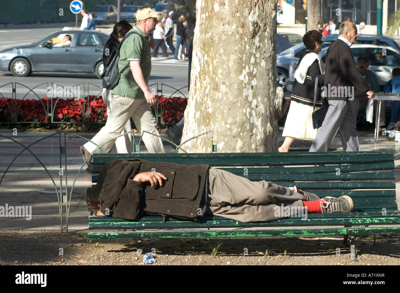 Obdachloser auf Stadtzentrum Bank während des Tages schlafen Stockfoto