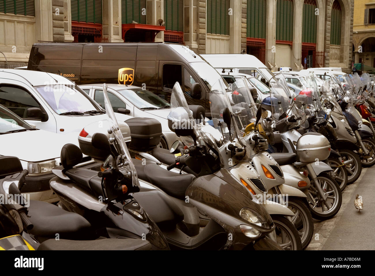 UPS-Lieferwagen kuschelt sich in Parkplatz unter Motorrädern auf Parkplatz in Florenz Italien Stockfoto