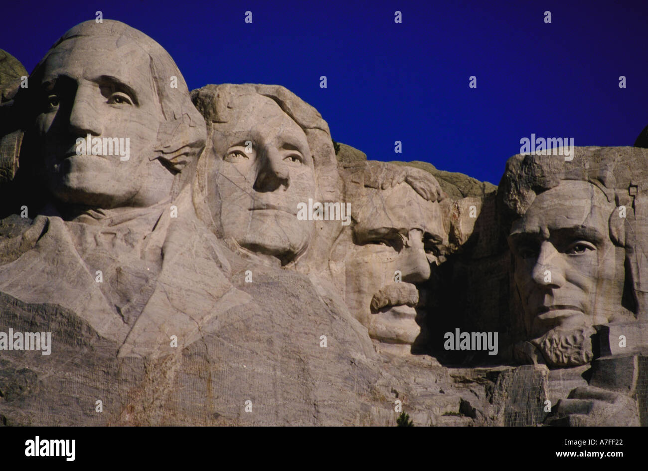 Mount Rushmore mit Gesichtern von George Washington Thomas Jefferson Theodore Roosevelt und Abraham Lincoln gegen blauen Himmel Stockfoto