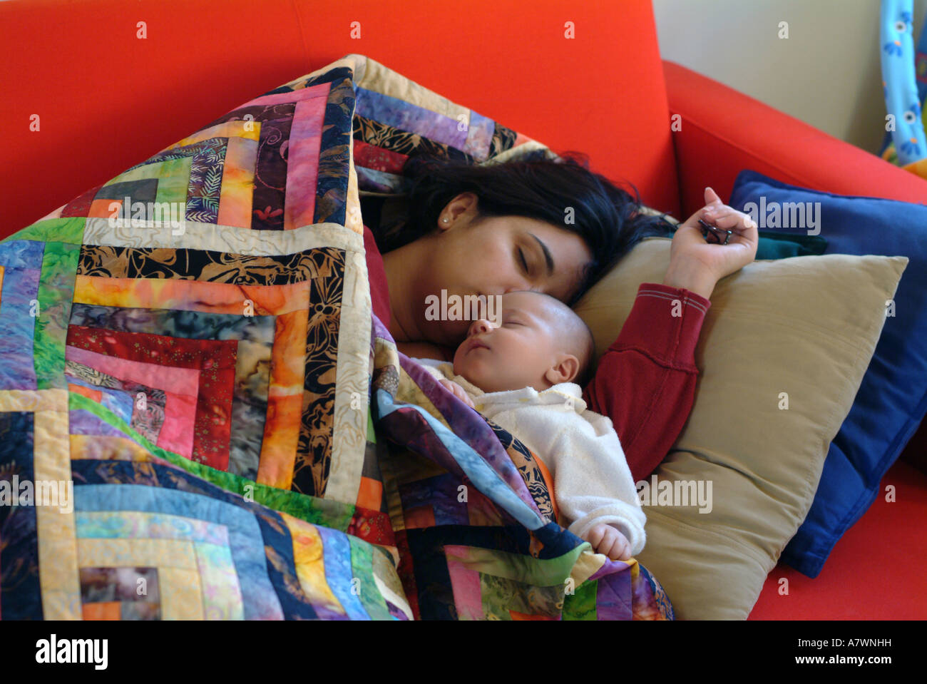 Hispano-amerikanischen Mutter und zwei 2 Monate alten Sohn Nickerchen ein auf der Couch. Stockfoto