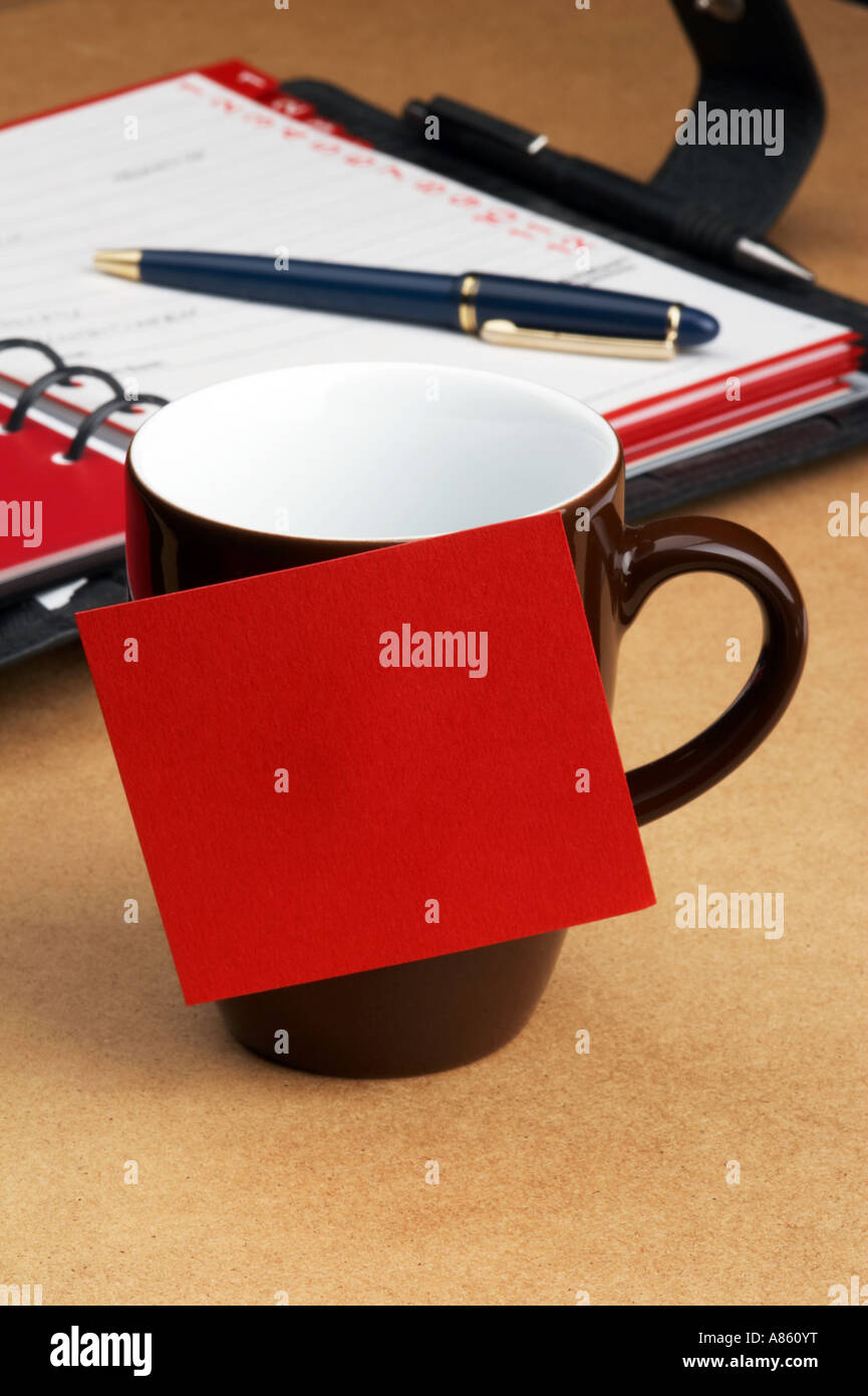 Tasse Kaffee mit Post-It auf dem Schreibtisch Stockfoto