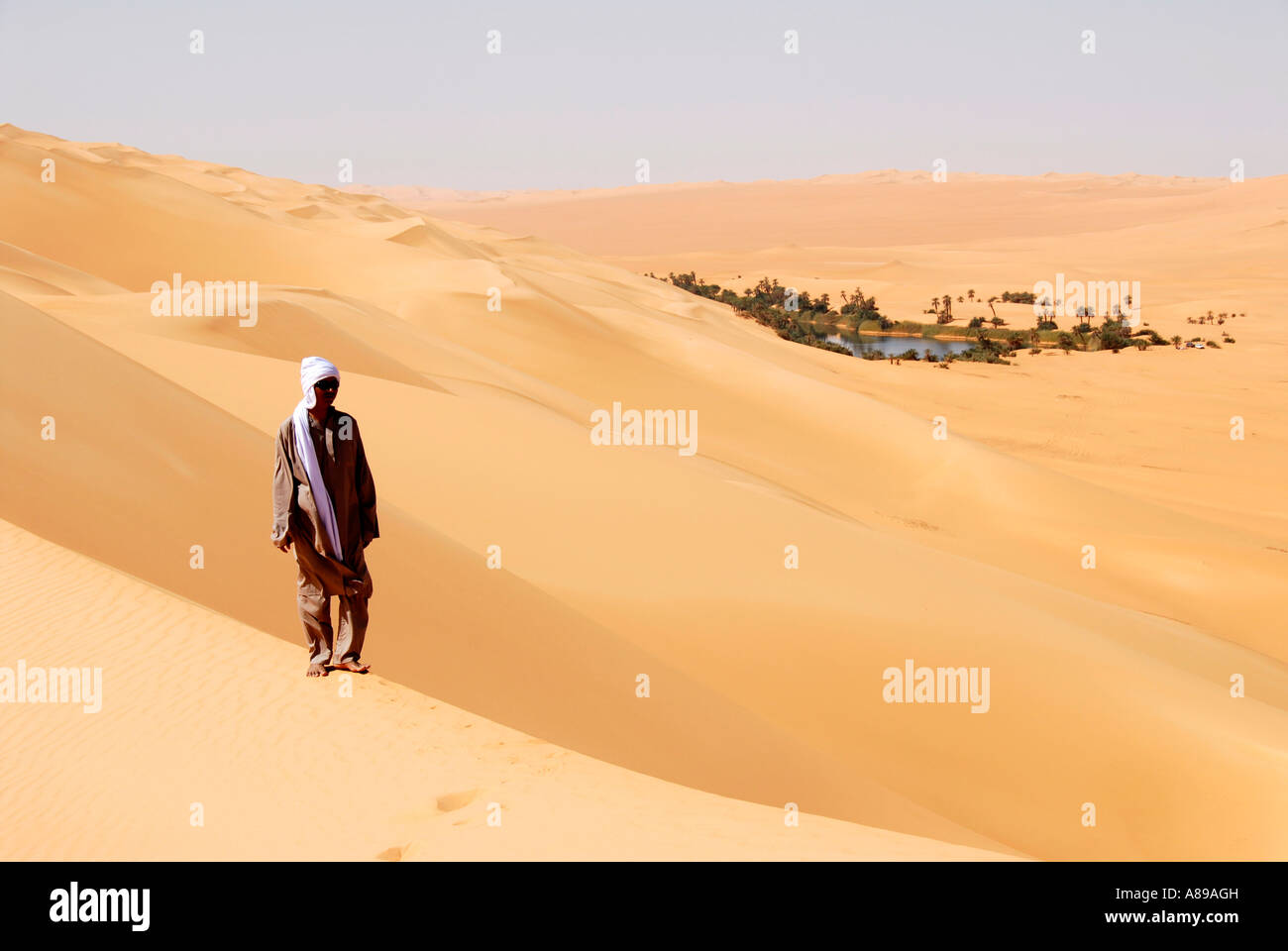 Tuareg Spaziergänge durch Wüstensand und Uhren eine Oase in der Ferne Umm el Ma Mandara Libyen Stockfoto