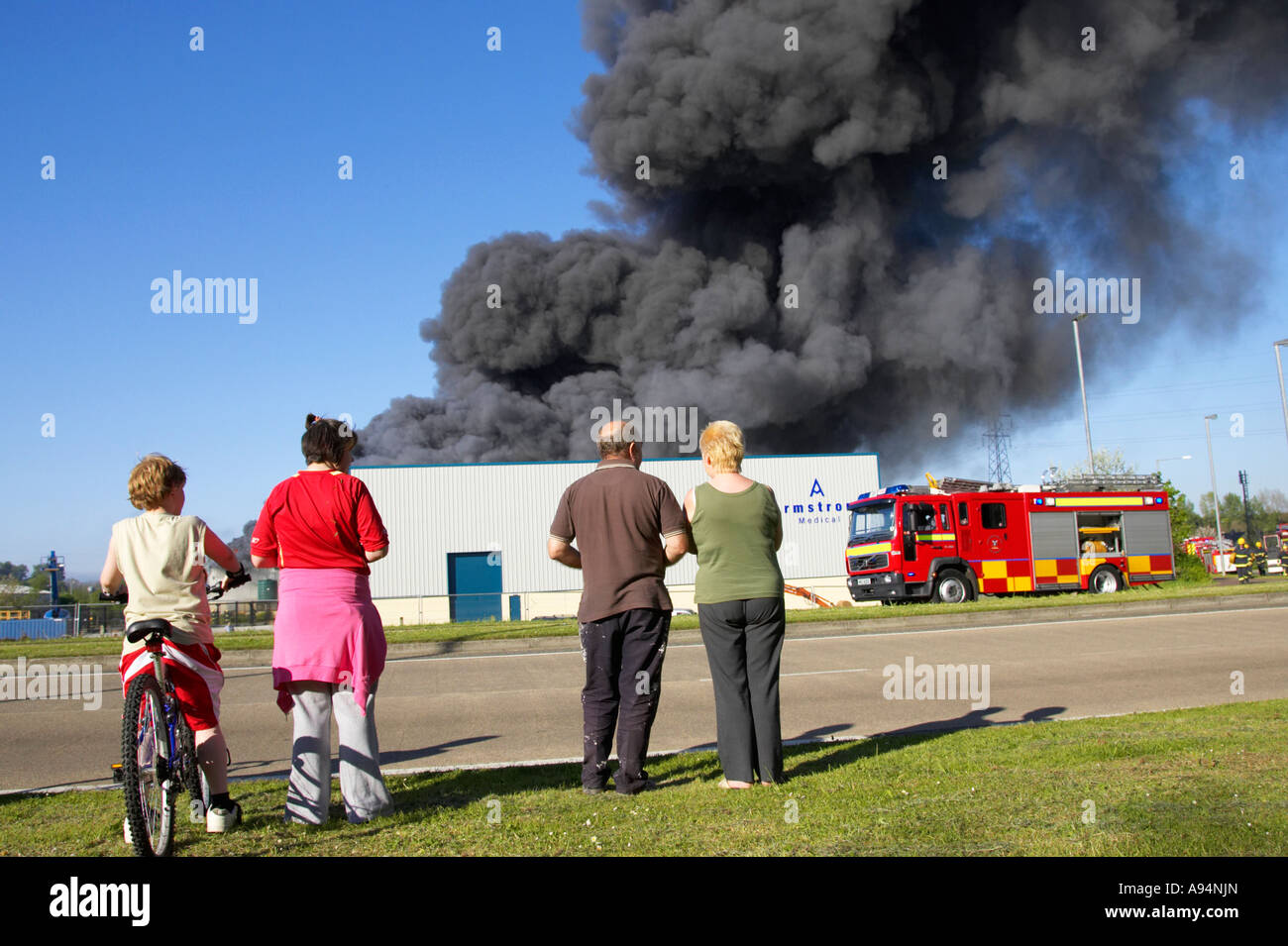 Gruppe von Menschen beobachten, Feuer und Rauchfahne aus industriellen Feuer an medizinischen Lager Geschäftsräume coleraine Stockfoto