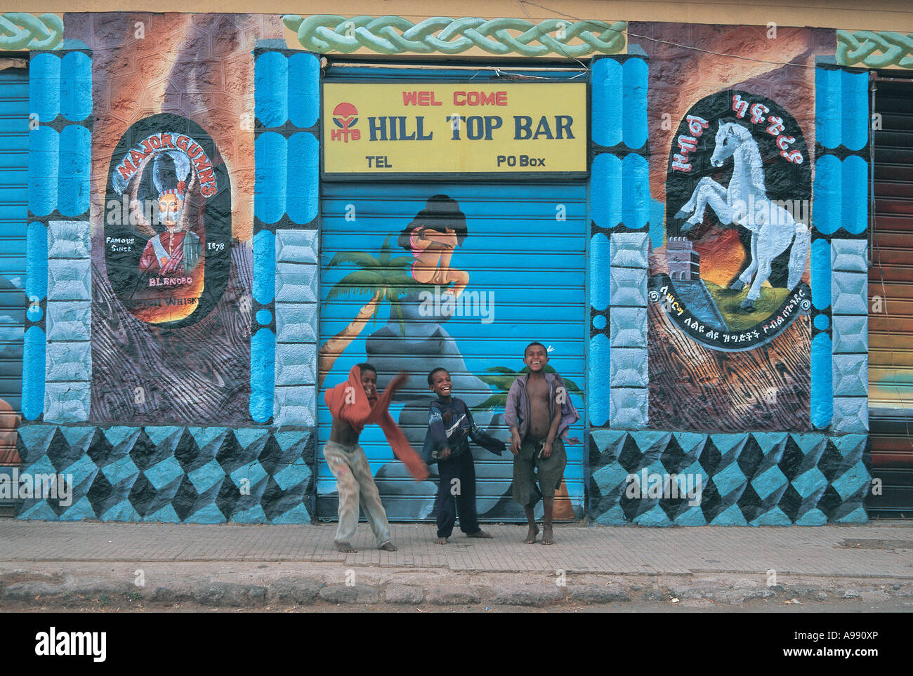 Kinder spielen vor Wandmalereien auf Straßen von Gondar Äthiopien Stockfoto
