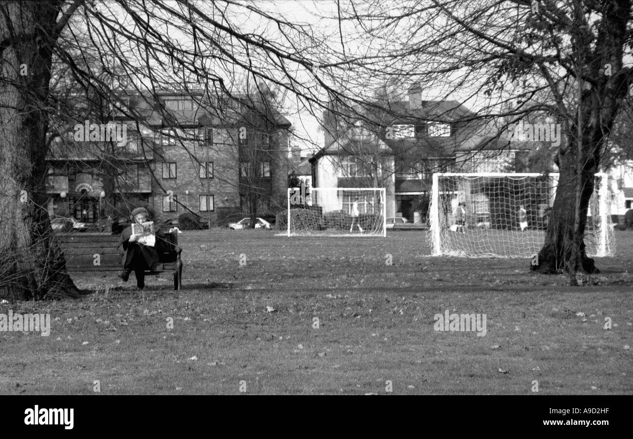 Ansicht von Hendon Park mit ältere Frau sitzen auf Bank und liest Zeitung Nord-London-England-Großbritannien-Europa Stockfoto