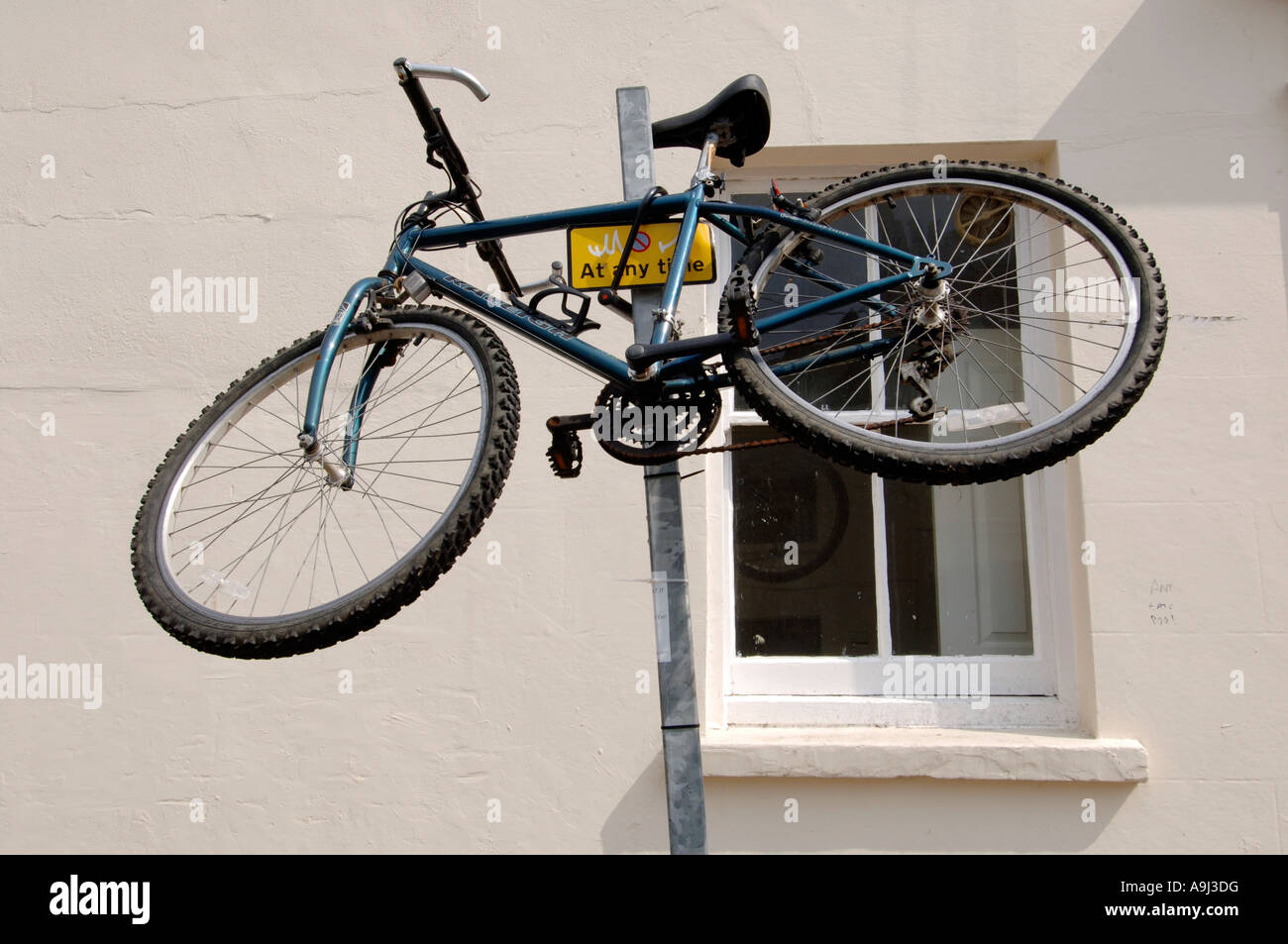 Ein Mountainbike von Raleigh wird auf Parkplatz Einschränkung Masten auf einer Straße der Stadt gesichert. Stockfoto