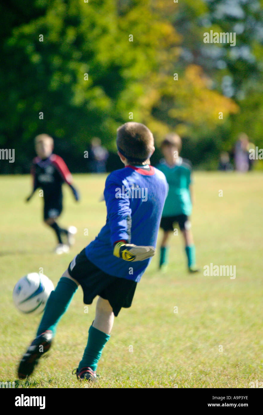 Junge uniformierte Jungs Fußball spielen Stockfoto