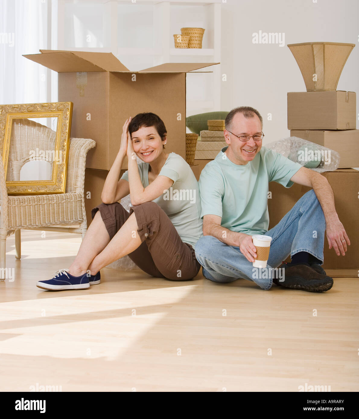Paar am Boden neben Umzugskartons Stockfoto