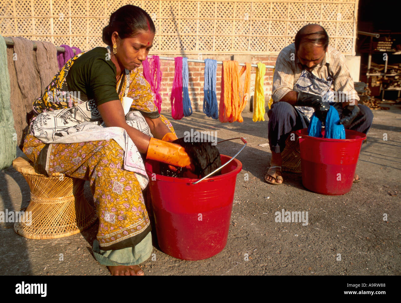 Auszubildende Hand-Färben Yarnl mit natürlichen Farbstoff, der umweltfreundlich ist. Dhaka. Bangladesch Stockfoto
