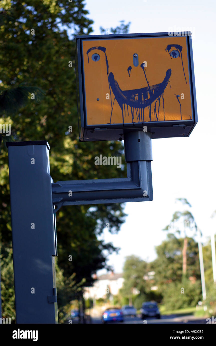 glückliches lachendes Gesicht gemalt auf einen Blitzer am Straßenrand gatso Stockfoto