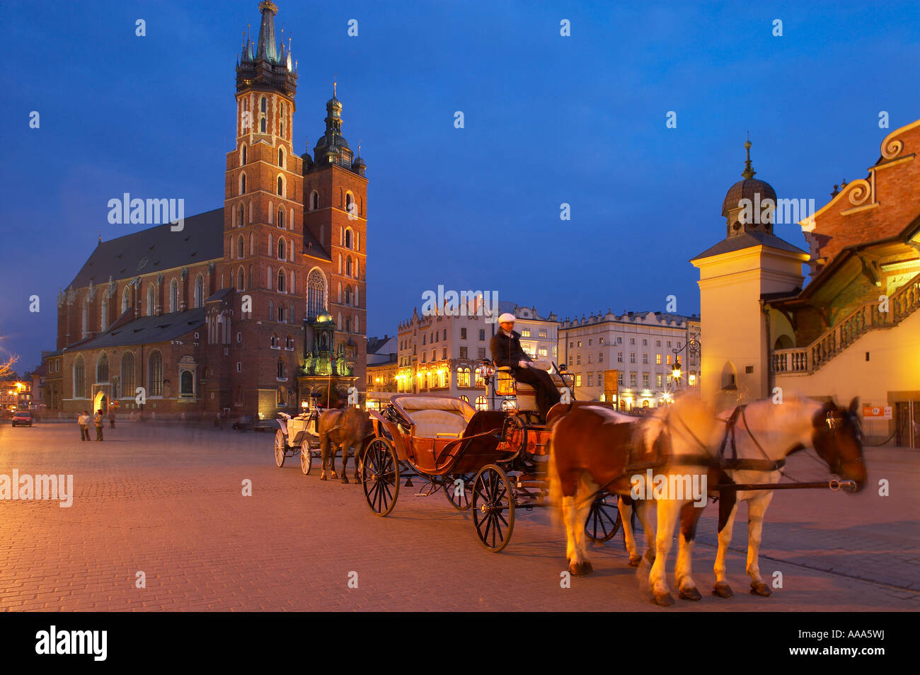 Pferd und Kutsche vor der Kirche St Mary und die Tuchhallen in der Main Market Square Rynek Glowny Krakau Polen Stockfoto