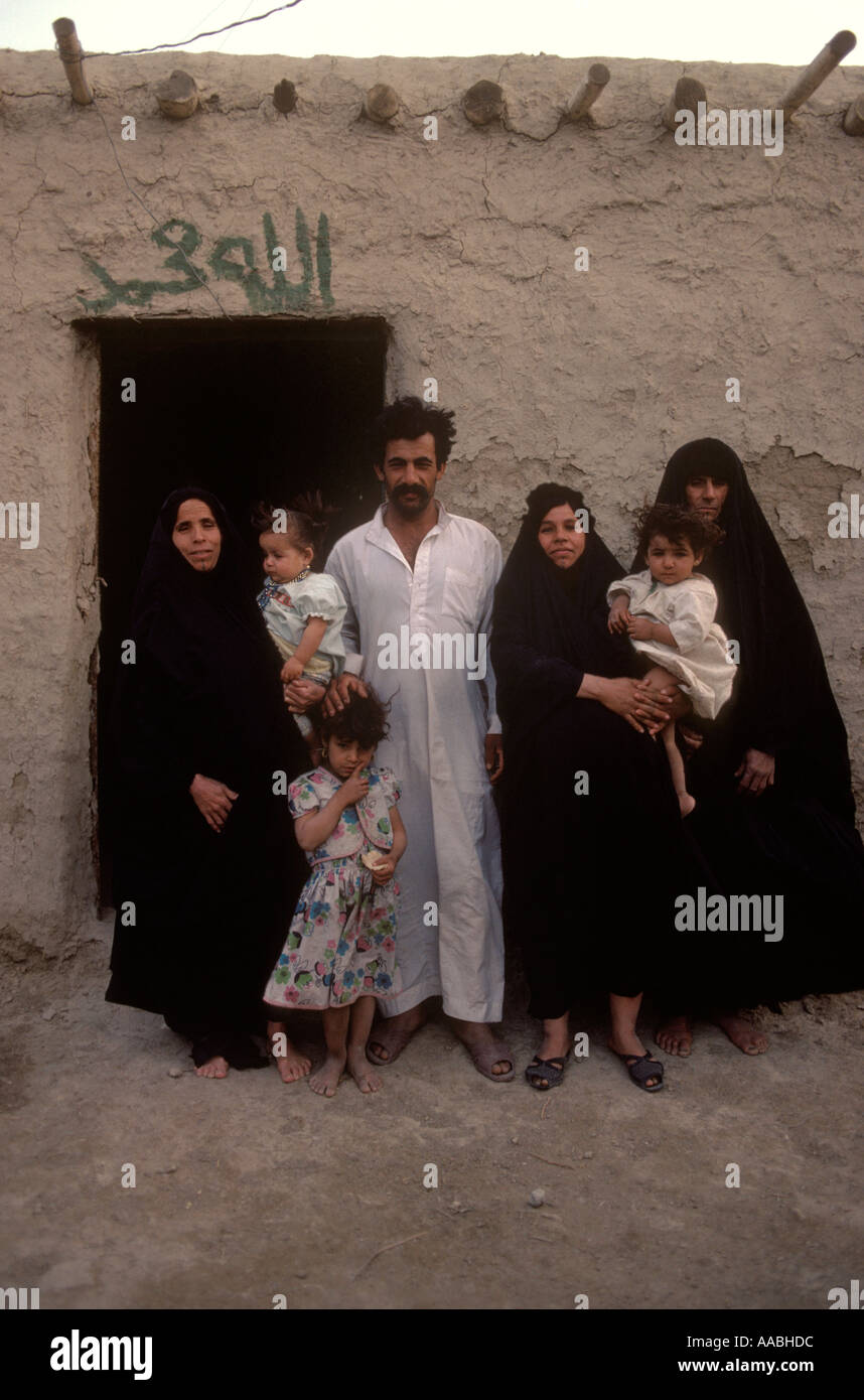 Marsh Arabs polygamöse Familie Irak. Familienvater mit drei Frauen, ihre Kinder stehen vor ihrem Haus im südlichen Irak. 1984 1980er HOMER SYKES Stockfoto