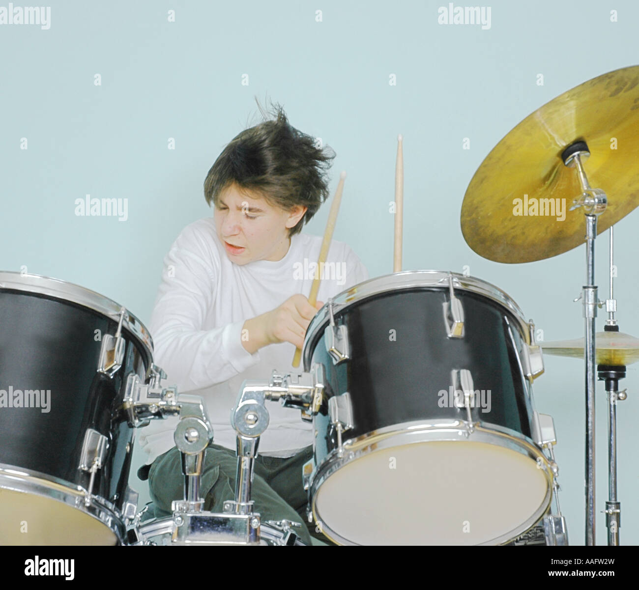 Teen Boy spielen eine Reihe von Trommeln. Stockfoto