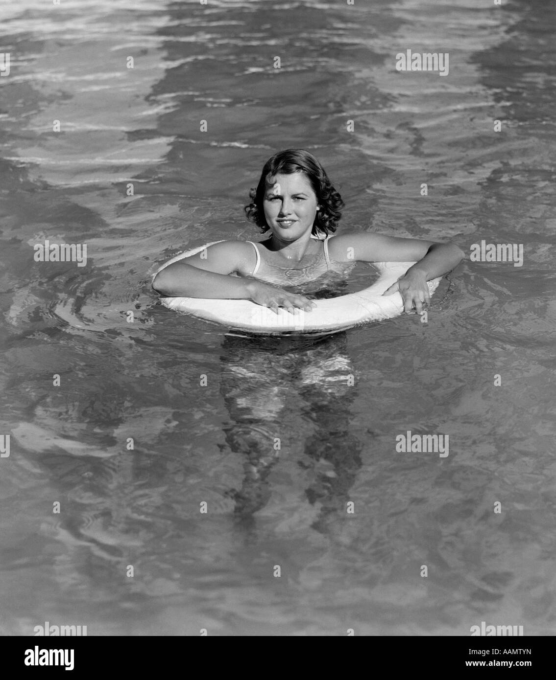 1930ER JAHREN FRAU IM POOL IM INNENROHR BLICK IN DIE KAMERA Stockfoto