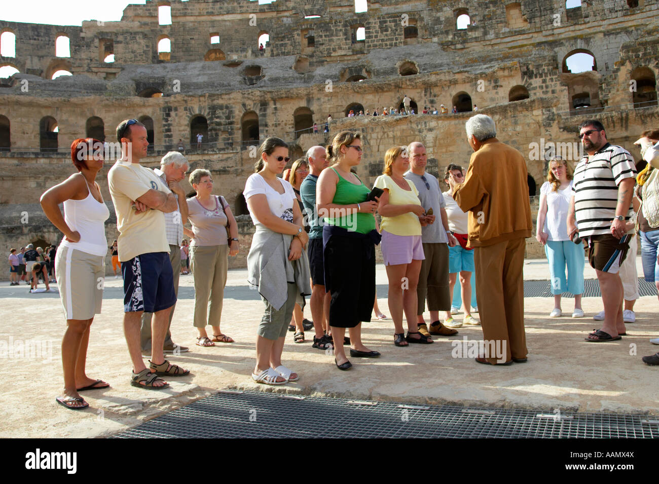 Nahaufnahme, als Reiseleiter über Gladiator Gruben auf dem Boden der Arena Gruppe von britischen Touristen erklärt Stockfoto