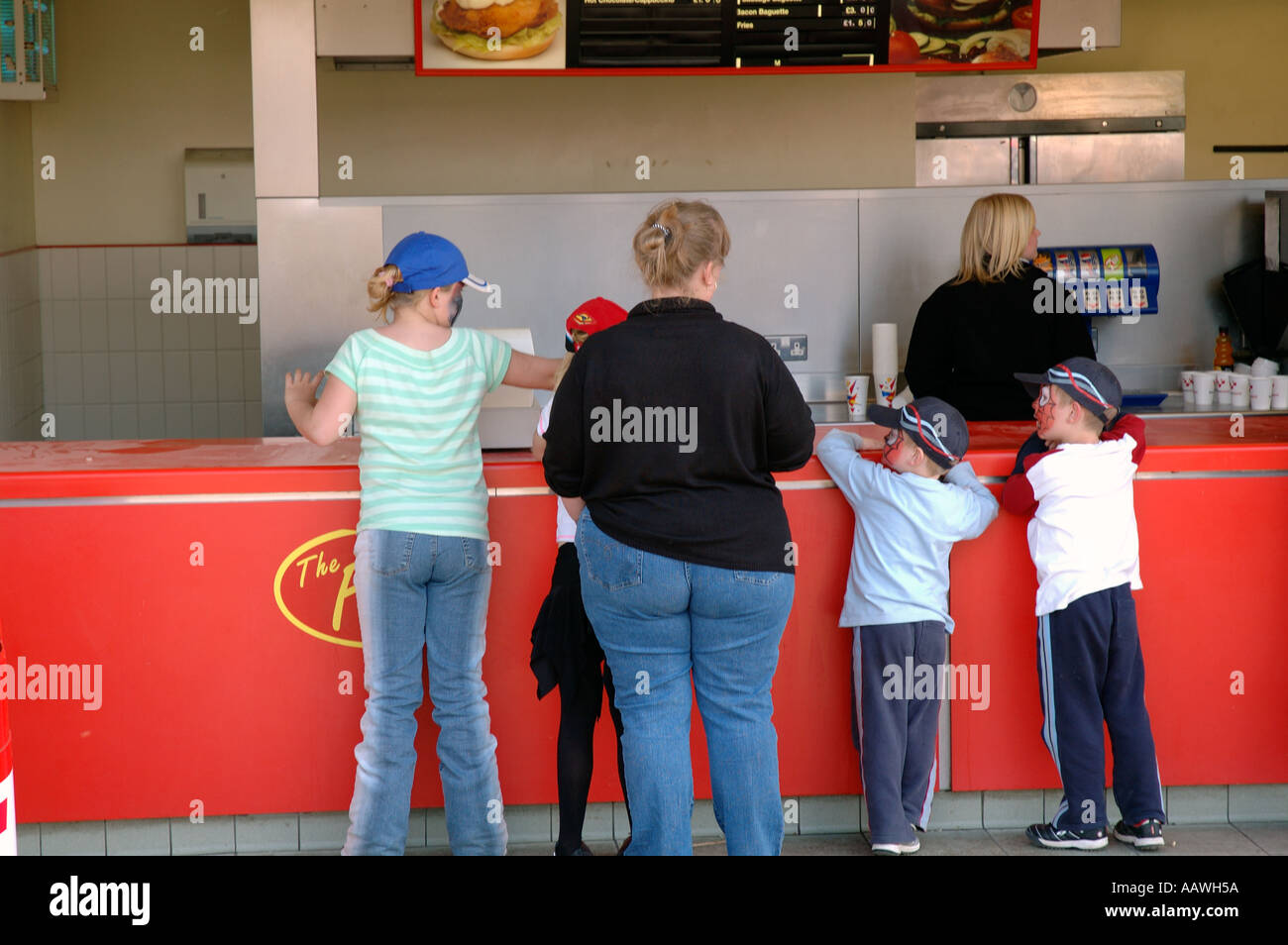 Familie mit übergewichtige Mutter Bestellung Fast-Food und Getränke zum Mitnehmen zuwider. Stockfoto