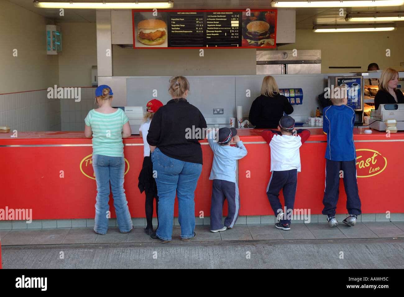 Familie mit übergewichtige Mutter Bestellung Fast-Food und Getränke zum Mitnehmen zuwider. Stockfoto