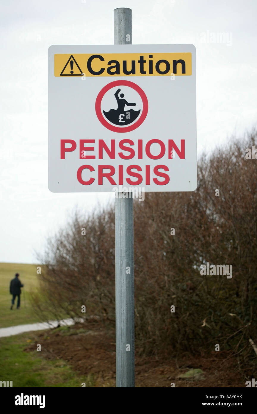 Ein Schild mit der Aufschrift der Wortes Vorsicht Rentenkrise mit Rentner im Park spazieren Stockfoto