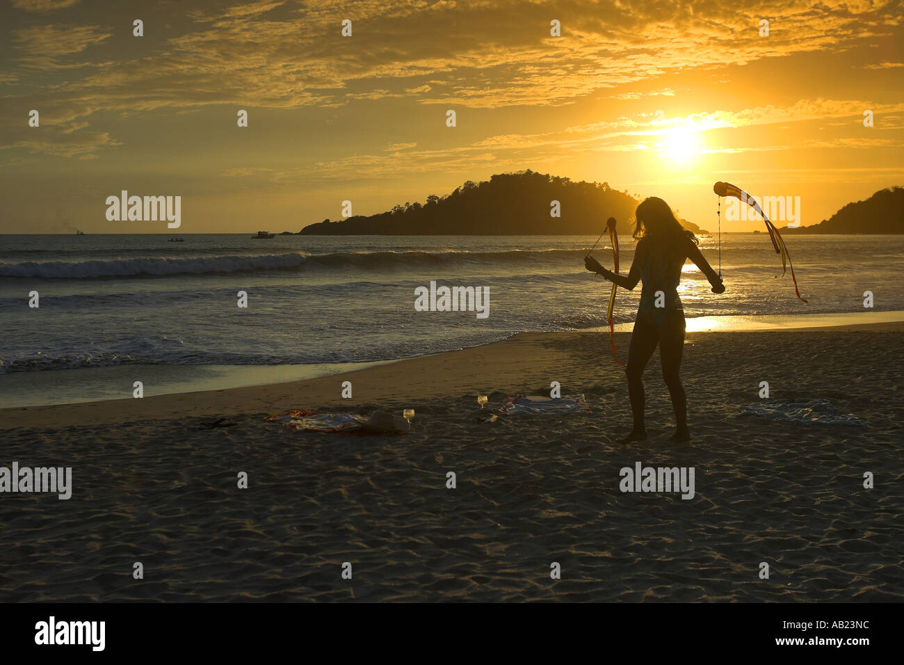 Badeanzug Mädchen drehte Poi Bänder im Sonnenuntergang Palolem Beach Süd Goa-Indien Stockfoto