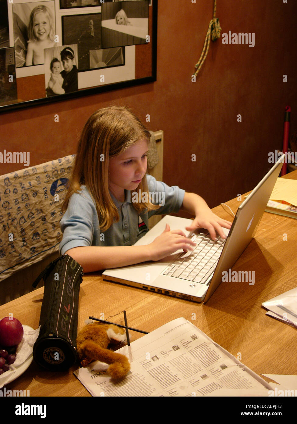 junges Mädchen, elf Jahre alt, machen Hausaufgaben oder loggen Sie sich auf Bebo auf ihrem Apple Powerbook Laptop-Computer, Aberystwyth Wales UK Stockfoto