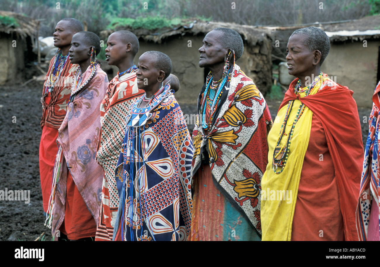 Afrika Kenia Masai Mara National Reserve Massai Frauen singen gekleidet in traditionellen Kanga Tücher und Perlen Schmuck Stockfoto