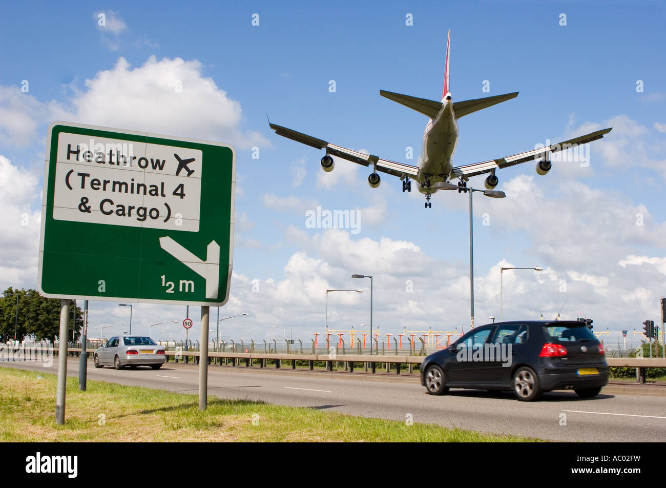 Straßenschild an der A4 für Heathrow Flughafen mit einem niedrig fliegenden Flugzeug über dem Kopf vorbei Stockfoto