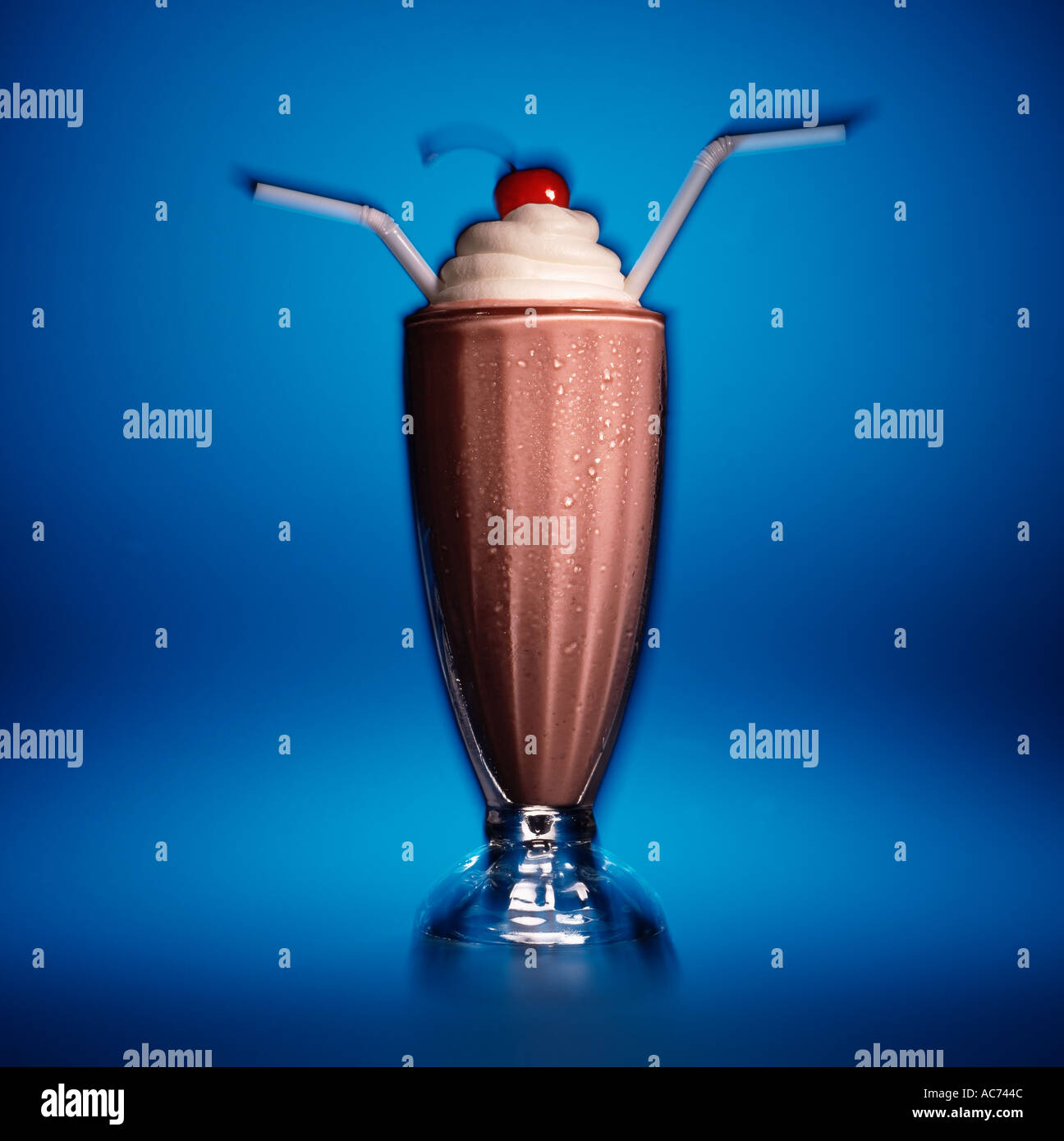 Schoko Milchshake mit zwei Strohhalmen auf blauem Hintergrund ...