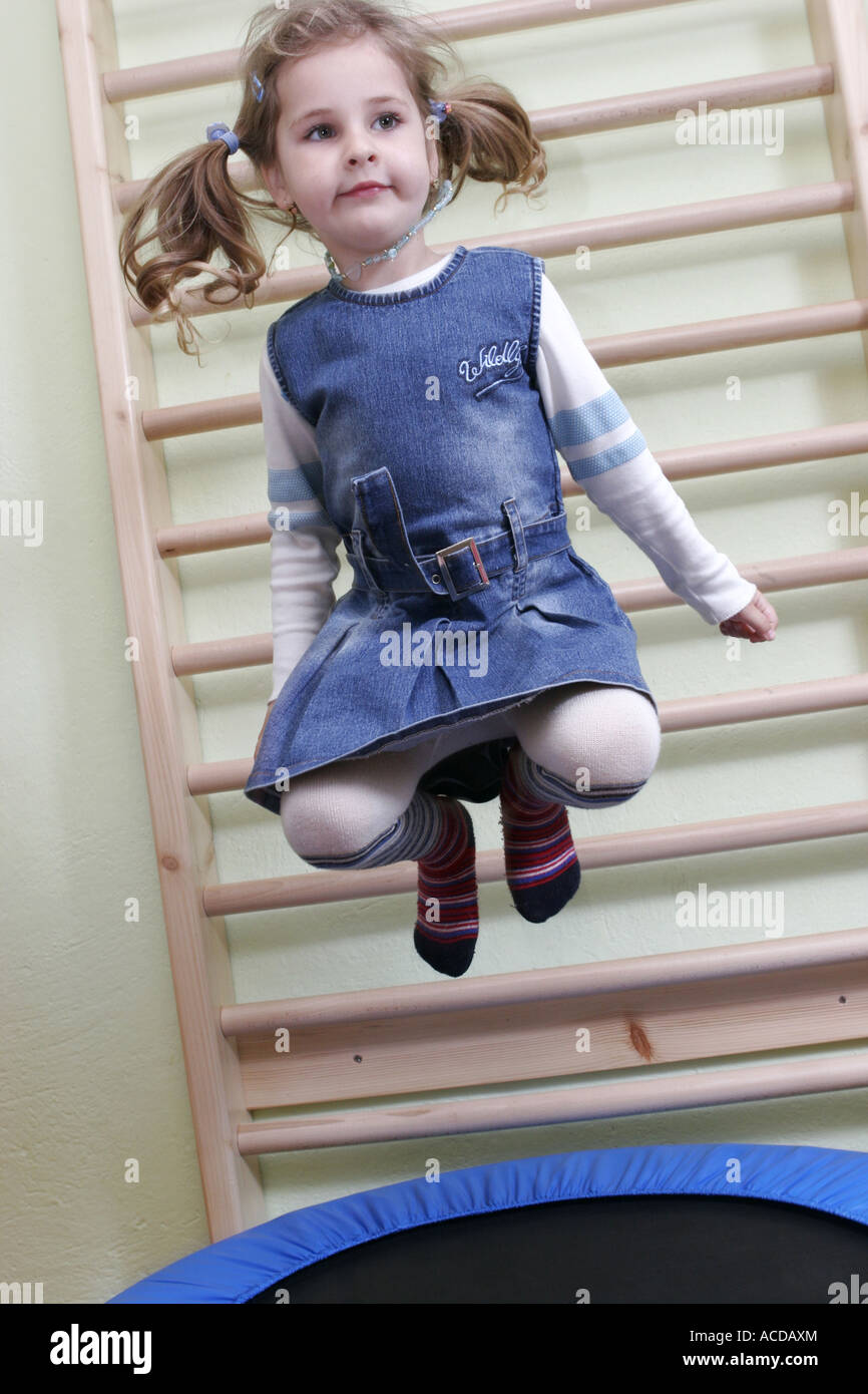 Ein kleines Mädchen ist am Trampolin springen. Stockfoto