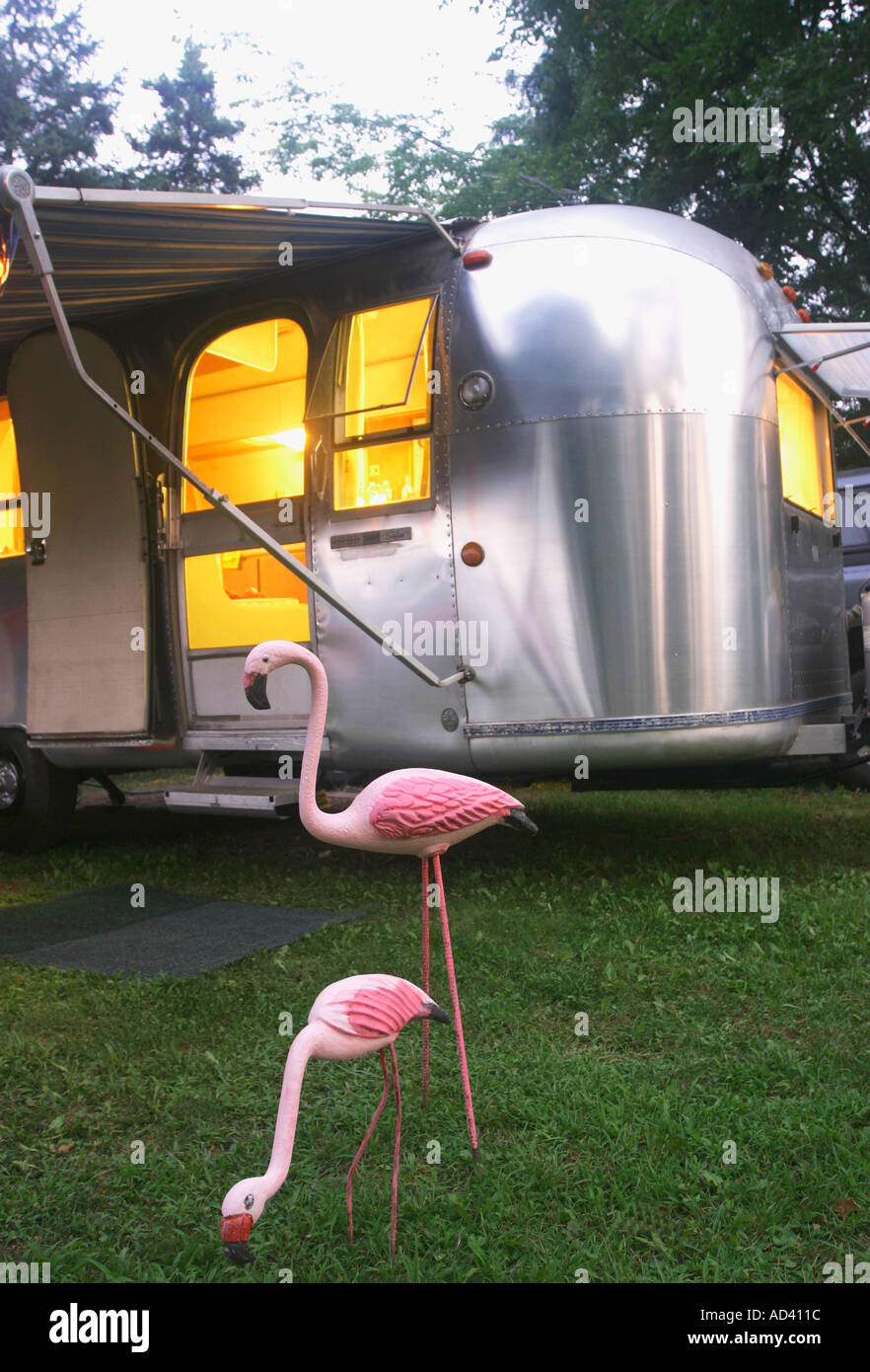 Antike rosa Flamingos in der Nähe von Jahrgang 1968 Airstream Wohnwagen Stockfoto