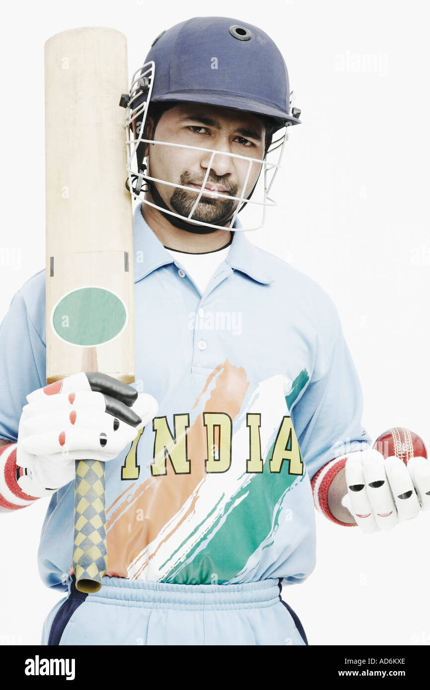 Porträt eines jungen Mannes hält eine Grille, Fledermaus und ein Cricketball Stockfoto