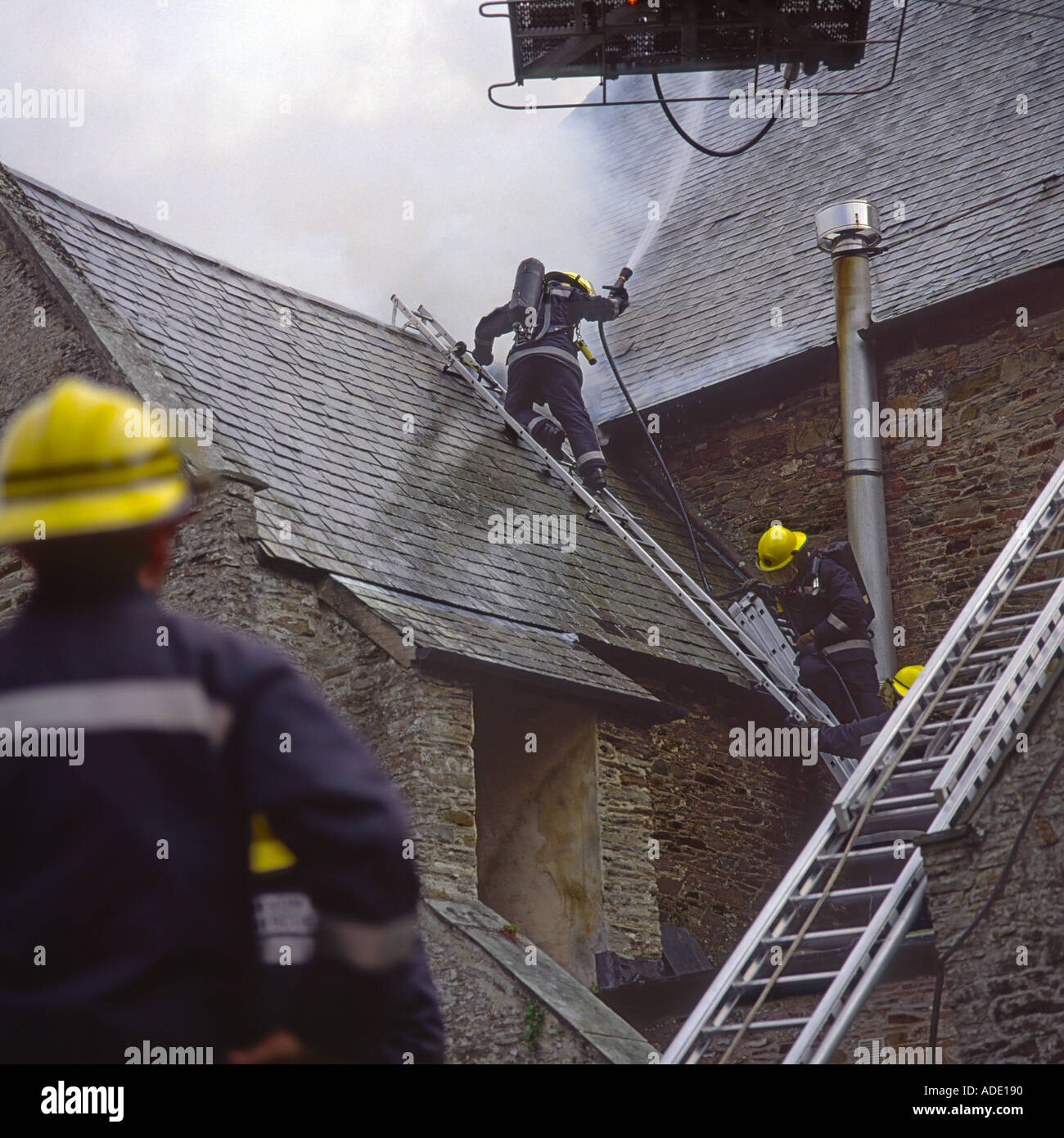 Feuerwehrmänner bekämpfen Dach Brandgefahr durch Kleinkinder an der St. Brannocks Kirche Braunton North Devon in England Stockfoto