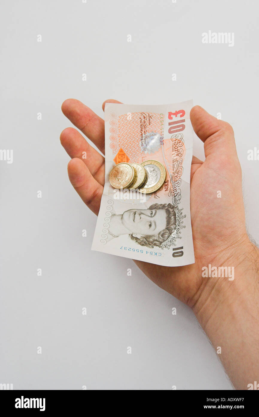 UK Pound Sterling Bargeld in der hand Stockfoto