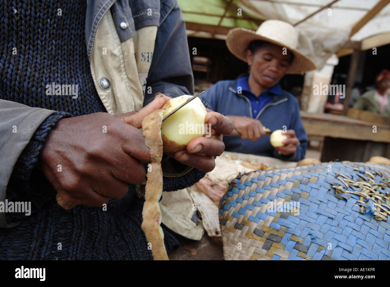 Frau Kartoffelschälen auf dem Lebensmittelmarkt, Ambositra, Madagaskar Stockfoto