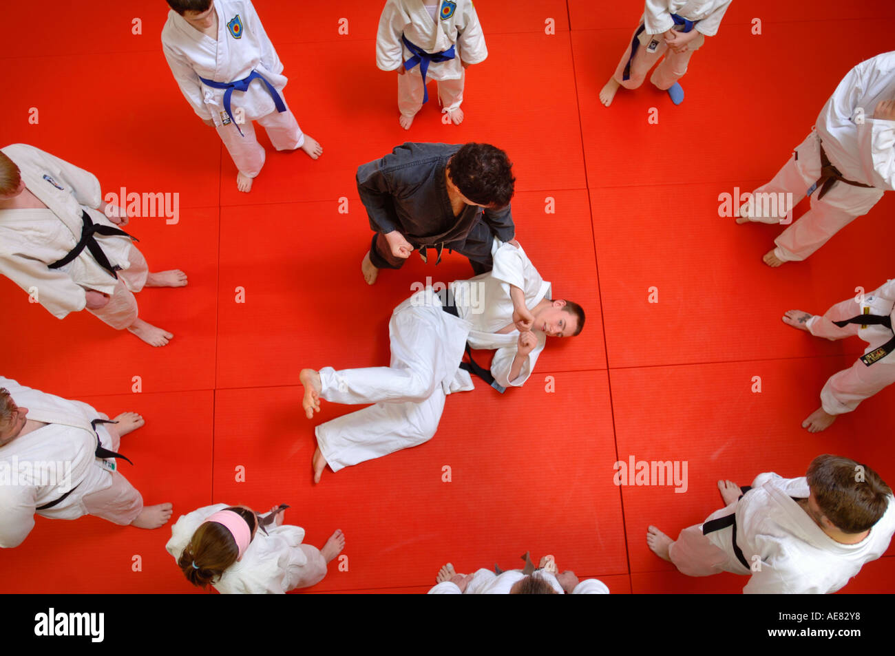 DRAUFSICHT VON KINDERN UND ERWACHSENEN LERNEN JUDO IN EINEM JUGENDZENTRUM IN ABINGDON OXFORDSHIRE UK Stockfoto