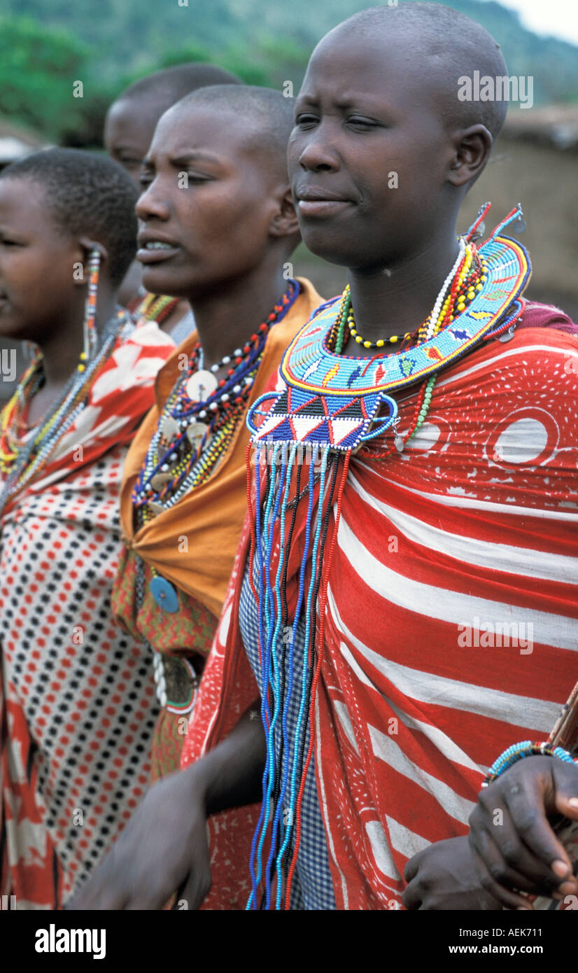 Afrika Kenia Masai Mara National Reserve junge Massai Frauen in traditionellen Kanga Tücher und Perlen Schmuck in ihrer manyatta Stockfoto