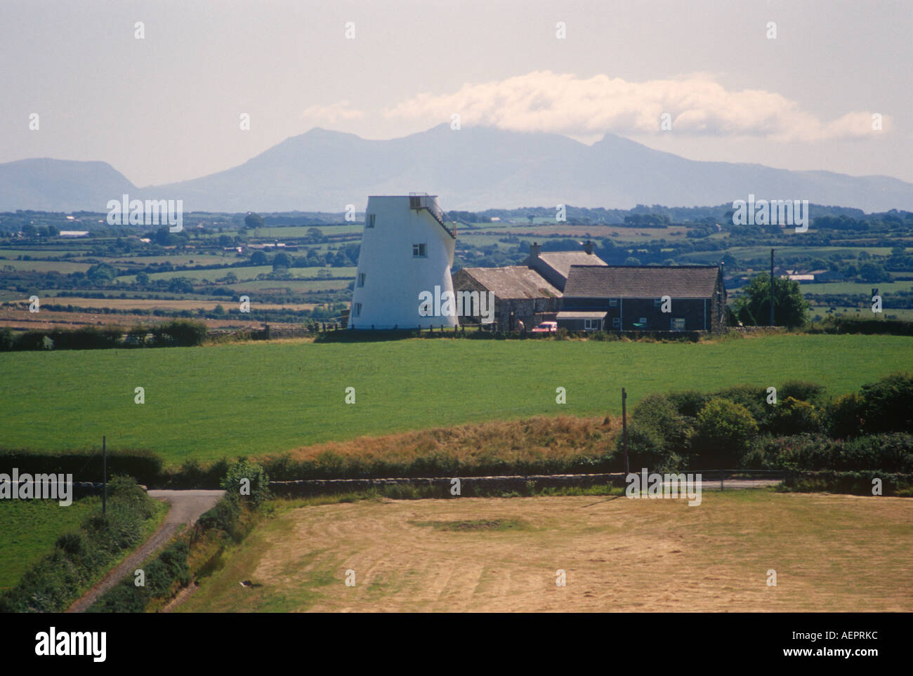 Ausgedienten Windmühle mit Snowdonia hinter Anglesey Nord-West-Wales Stockfoto