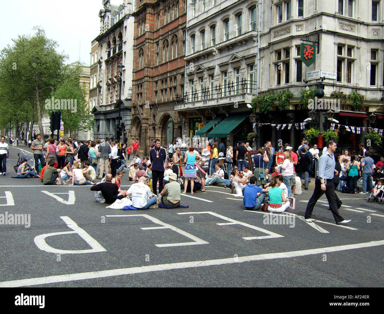 Leute sitzen im Parlament street London Stockfoto