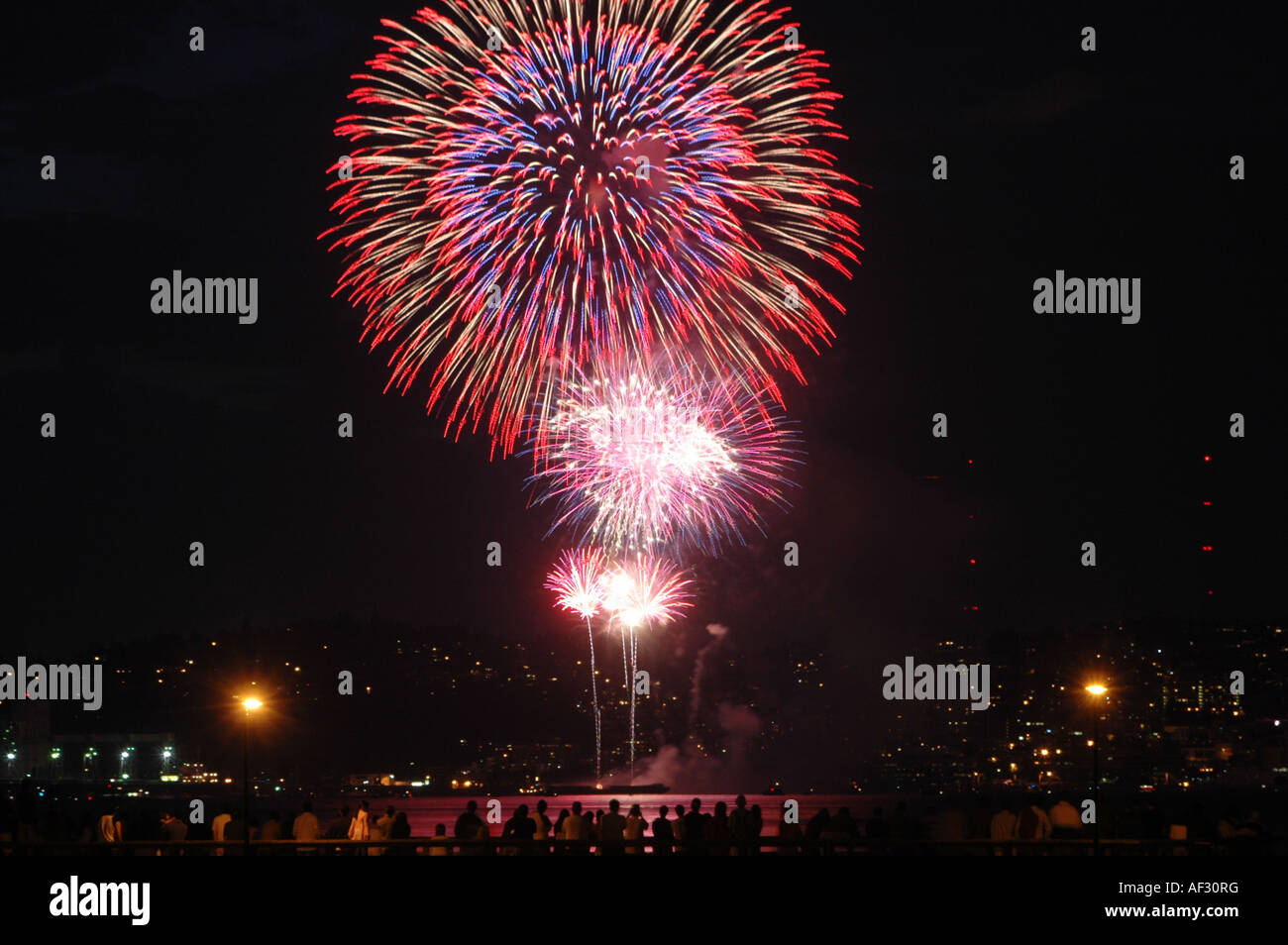 Die Silhouetten von Menschen, die eine Feier Feuerwerk genießen. Stockfoto