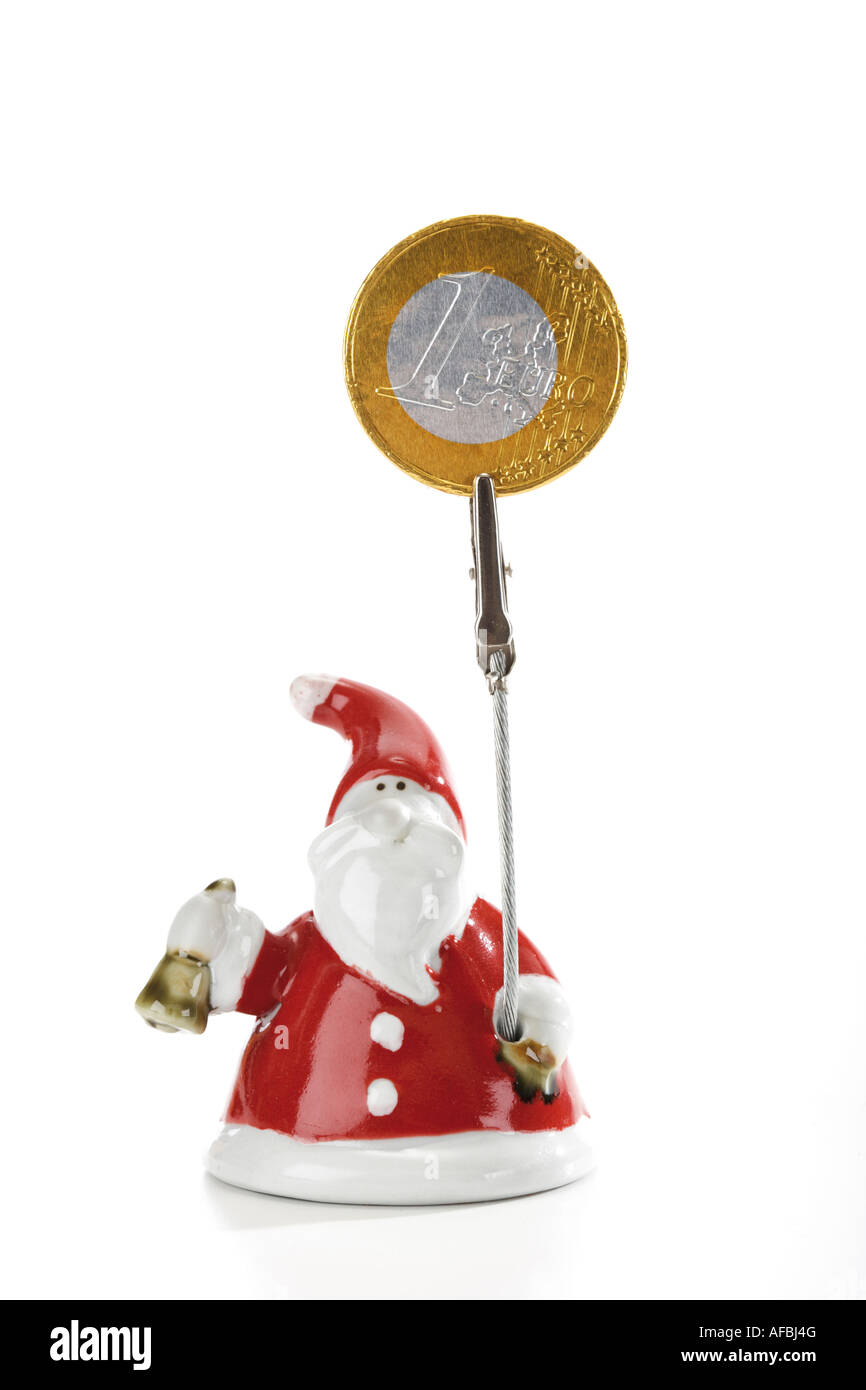 Santa Claus Figur hält Euro-Münze Stockfoto