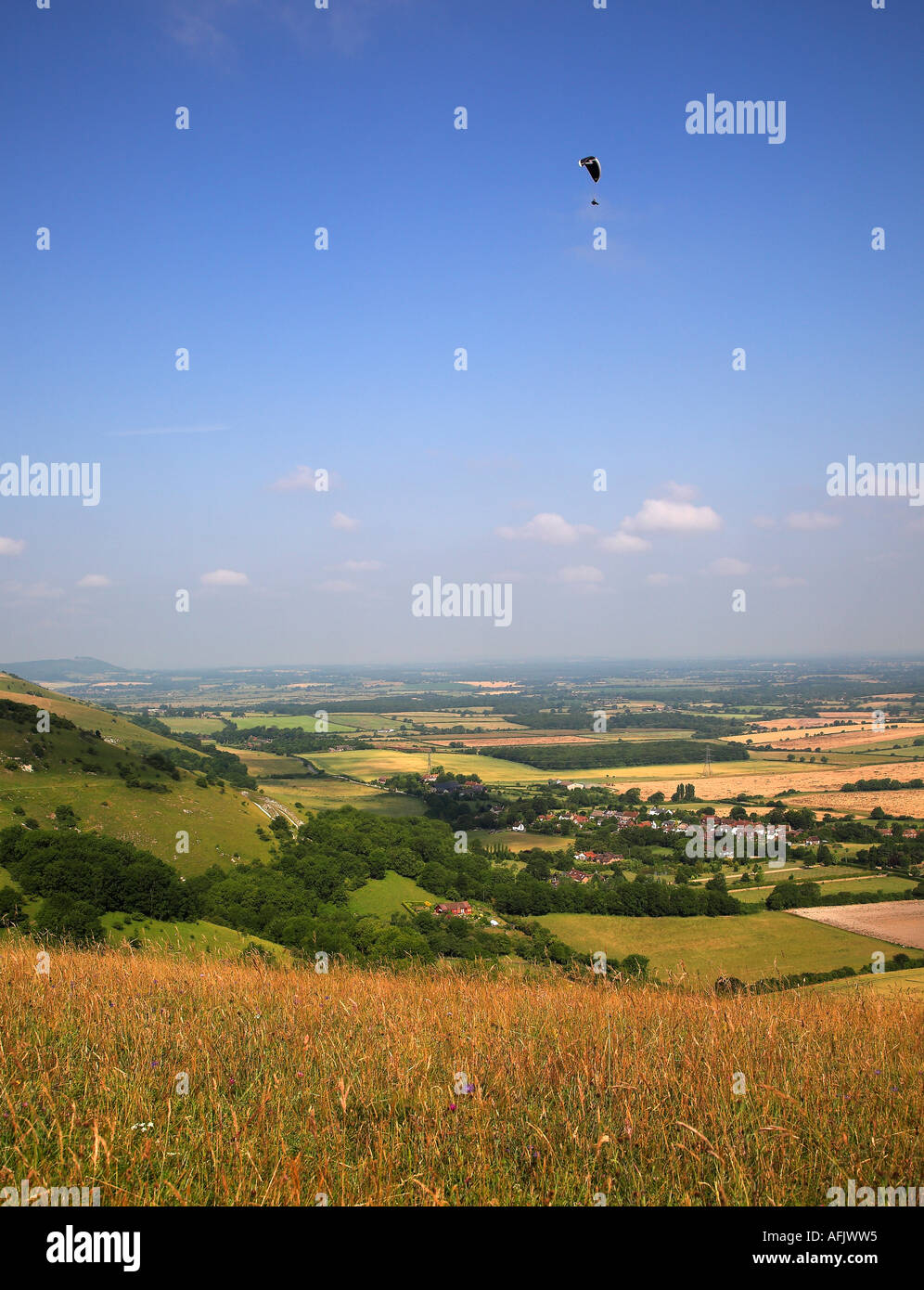 Mann über die Southdowns Devils Dyke West Sussex an einem schönen blauen Himmel Tag parasailing. UK Stockfoto