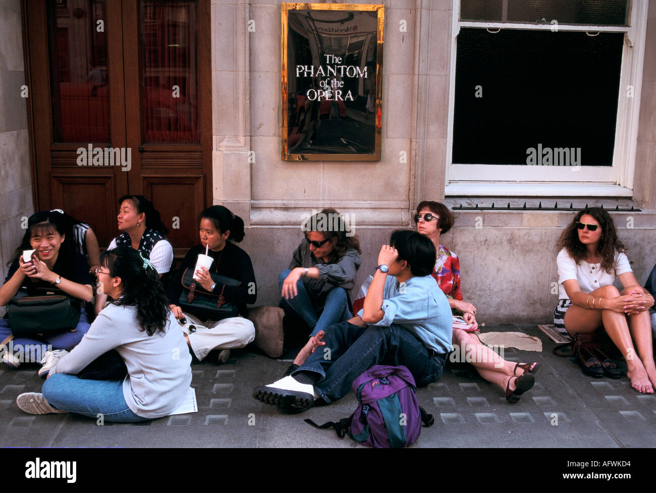 Touristen, die sich für Theaterkarten für das Phantom der Oper im her Majesty's Theatre im West End von London anstellen 1990s, Großbritannien, HOMER SYKES Stockfoto