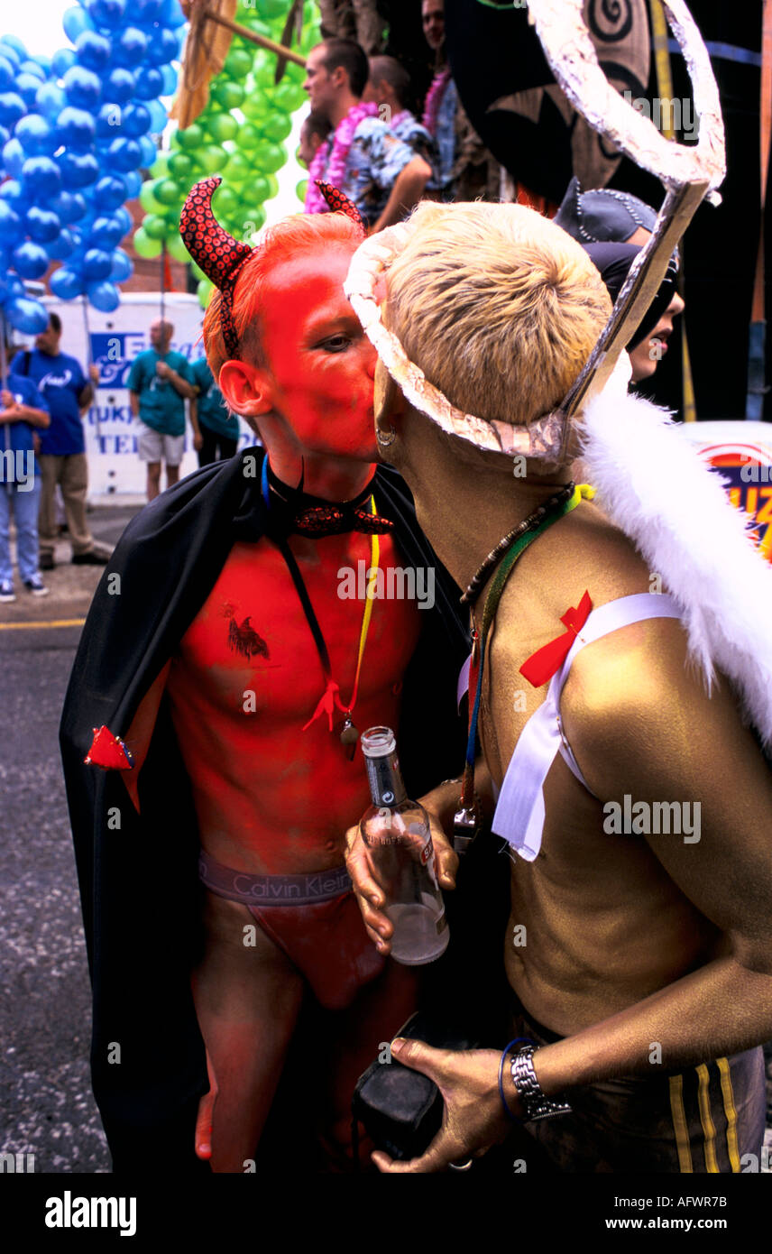 Manchester Pride Festival 1990s Gayfest UK LGBT zwei Männer, die als Teufel und Engel gekleidet sind, küssen sich während der Parade in der Stadt. 1999 England Stockfoto