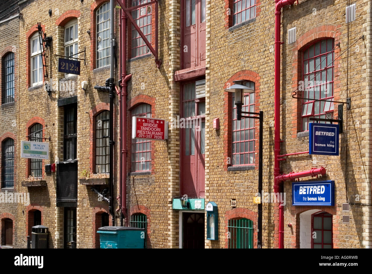 Fenster des umgebauten Lagerhallen in der Nähe von Tower Bridge. Horselydown Road, London, England Stockfoto