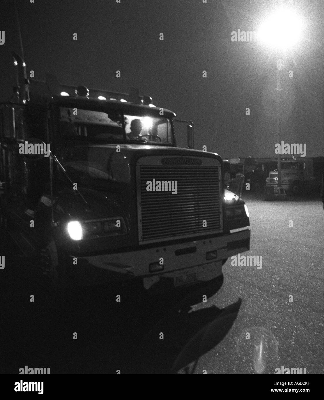 LKW-Fahrer in der Kabine in der Nacht Stockfoto