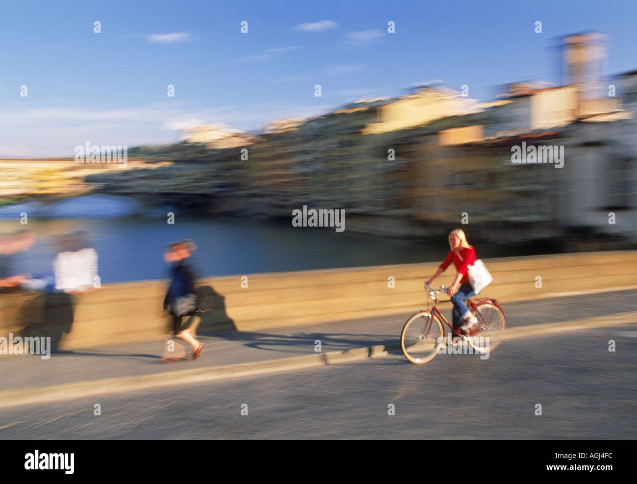 Weiblich, Radfahren am Ponte Sankt Trinita über Fluss Arno in Florenz Stockfoto