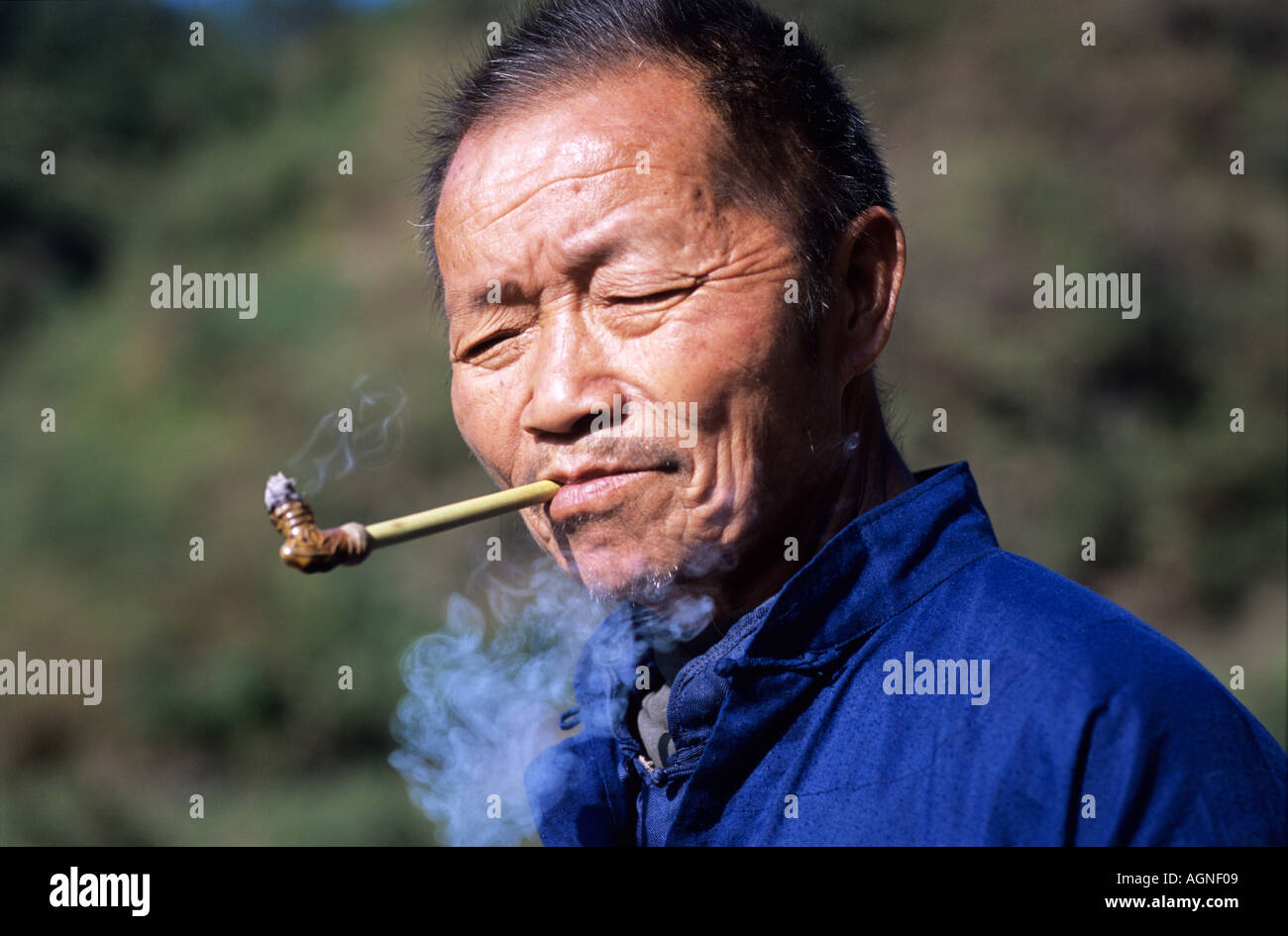 Mitglied der Miao-Minderheit raucht seine Pfeife Luobang Dorf Guizhou Provinz China Stockfoto