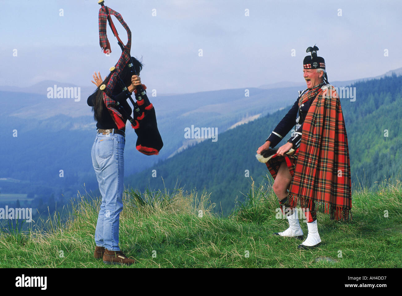 Dudelsackspieler in den schottischen Highlands Vermietung touristischen peek unter seinem kilt Stockfoto