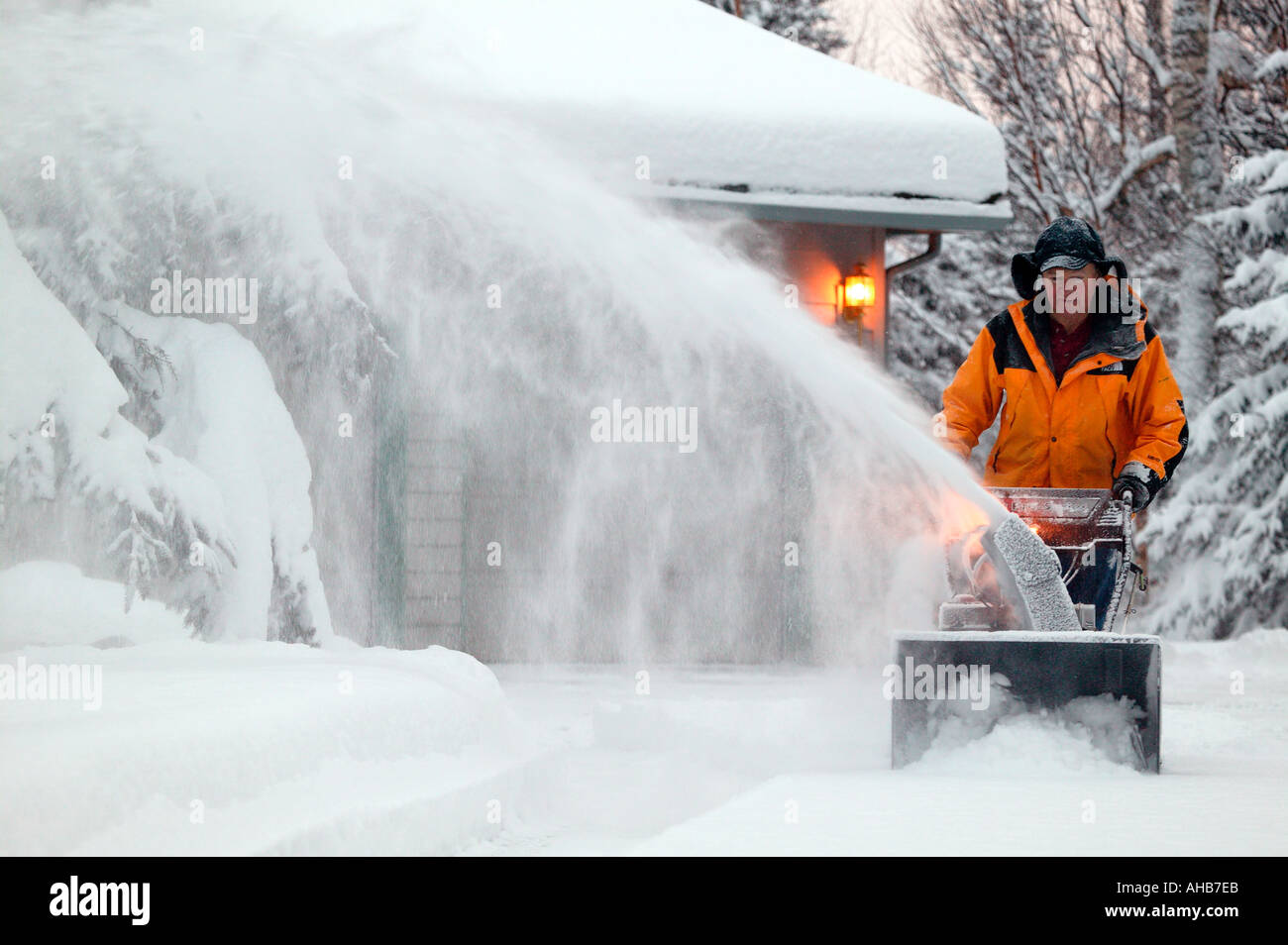 Mann Snowblowing seiner Einfahrt nach frischen Winter Schneesturm Modell Eigentum veröffentlicht Stockfoto
