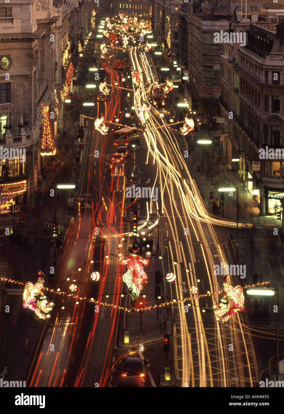 Regent Street West End of London Blick auf beleuchtete Weihnachtsdekorationen in der Nacht mit Bewegung Unschärfe Fahrzeug Ampel Trails England Großbritannien Stockfoto